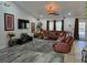 Spacious living room featuring a large sectional sofa and flat-screen TV at 437 Grand Reserve Dr, Davenport, FL 33837