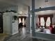 Open concept living area with grey tile floors and a red couch at 437 Grand Reserve Dr, Davenport, FL 33837