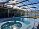 Large screened pool and spa with a covered patio at 437 Grand Reserve Dr, Davenport, FL 33837