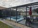 Relaxing pool and spa with screened enclosure, patio furniture, and landscaping at 437 Grand Reserve Dr, Davenport, FL 33837