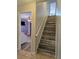Modern staircase with wood-look tile and neutral colors at 437 Grand Reserve Dr, Davenport, FL 33837