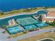 Tennis and pickleball courts with lake view at 4505 Back Nine Dr, Winter Haven, FL 33884