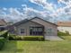 House with screened enclosure and well-manicured hedges at 4505 Back Nine Dr, Winter Haven, FL 33884