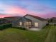 Home with screened lanai at sunset at 4505 Back Nine Dr, Winter Haven, FL 33884