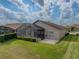 House with screened enclosure and grassy backyard at 4505 Back Nine Dr, Winter Haven, FL 33884