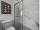 Walk-in shower with grab bars and tiled walls at 4505 Back Nine Dr, Winter Haven, FL 33884