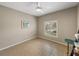 Cozy bedroom with tile floors, large window with blinds, ceiling fan at 4505 Back Nine Dr, Winter Haven, FL 33884