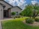 Landscaped front yard with palm trees, shrubs, and a paved walkway at 4505 Back Nine Dr, Winter Haven, FL 33884