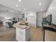 Open kitchen with breakfast bar, stainless steel appliances, and view of living room at 4505 Back Nine Dr, Winter Haven, FL 33884