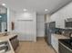 Kitchen with stainless steel appliances, white cabinets, and laundry closet at 4505 Back Nine Dr, Winter Haven, FL 33884