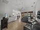 Bright living room with gray sofas, views of the kitchen and screened lanai at 4505 Back Nine Dr, Winter Haven, FL 33884