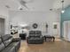 Spacious living room with gray sofas and views of a bedroom and lanai at 4505 Back Nine Dr, Winter Haven, FL 33884