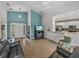 Open living room with gray sofas, a view of the kitchen, and access to the screened lanai at 4505 Back Nine Dr, Winter Haven, FL 33884