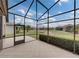 Screened patio with view of the backyard and neighboring houses at 4505 Back Nine Dr, Winter Haven, FL 33884