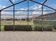Spacious screened patio overlooking a pond and lush landscaping at 4505 Back Nine Dr, Winter Haven, FL 33884
