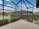 Large screened patio with diagonal tile flooring and access door at 4505 Back Nine Dr, Winter Haven, FL 33884