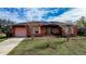 Fire damaged house needing repairs, with boarded windows at 517 Cipres Cir, Winter Haven, FL 33880