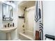 Bathroom with beige tile, a bathtub and a pedestal sink at 524 Arneson Ave, Auburndale, FL 33823