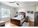 Bedroom with hardwood floors, a ceiling fan and large window at 524 Arneson Ave, Auburndale, FL 33823