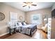 Bright bedroom with hardwood floors, a comfy bed, and window shutters at 524 Arneson Ave, Auburndale, FL 33823
