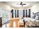 Spacious main bedroom with hardwood floors, large windows, and a ceiling fan at 524 Arneson Ave, Auburndale, FL 33823