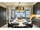 Bright dining room with a round table, lake view, and stylish light fixture at 524 Arneson Ave, Auburndale, FL 33823