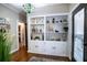Bright entryway with built-in shelving and hardwood floors at 524 Arneson Ave, Auburndale, FL 33823