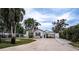 House exterior with palm trees and gated driveway at 524 Arneson Ave, Auburndale, FL 33823