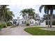 White house exterior with palm trees and circular driveway at 524 Arneson Ave, Auburndale, FL 33823