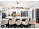 Modern kitchen with large island and six barstools at 524 Arneson Ave, Auburndale, FL 33823