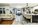 Open concept kitchen features granite island and breakfast bar, overlooking the dining area at 524 Arneson Ave, Auburndale, FL 33823