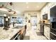 Large kitchen with island, granite countertops, and farmhouse sink at 524 Arneson Ave, Auburndale, FL 33823