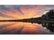 Stunning lakefront property with a vibrant sunset at 524 Arneson Ave, Auburndale, FL 33823