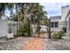 Brick pathway and wrought iron gates lead to a charming entryway at 524 Arneson Ave, Auburndale, FL 33823