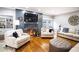 Living room features hardwood floors, fireplace, and comfortable seating at 524 Arneson Ave, Auburndale, FL 33823