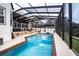 Inviting pool area with screened enclosure, deck, and brick pavers at 524 Arneson Ave, Auburndale, FL 33823