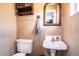 Small half bathroom with pedestal sink and toilet at 524 Arneson Ave, Auburndale, FL 33823