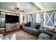Relaxing sunroom with comfortable seating and barn doors at 524 Arneson Ave, Auburndale, FL 33823