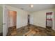 Bedroom with tile floors, built-in shelving, and adjacent bathroom at 615 E Haines Blvd, Lake Alfred, FL 33850