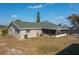 Tan house with green roof, screened patio, and grassy yard at 615 E Haines Blvd, Lake Alfred, FL 33850