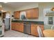 Kitchen features wood cabinets, stainless steel appliances, and a breakfast nook at 615 E Haines Blvd, Lake Alfred, FL 33850