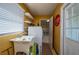 Functional laundry room with washer, dryer, sink, and ample shelving at 615 E Haines Blvd, Lake Alfred, FL 33850