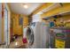 Laundry room with washer, dryer, and extra storage shelves at 615 E Haines Blvd, Lake Alfred, FL 33850