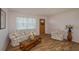 Living room with floral sofas, wood floors, and coffee table at 615 E Haines Blvd, Lake Alfred, FL 33850
