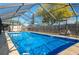 Refreshing screened pool perfect for relaxation at 615 E Haines Blvd, Lake Alfred, FL 33850