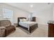 Spacious bedroom with a comfortable bed and recliner at 723 Chinoy Rd, Davenport, FL 33837