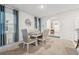Bright dining room with table and chairs, and view of entryway at 723 Chinoy Rd, Davenport, FL 33837