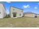 Two-story house with light green exterior and sliding glass door at 723 Chinoy Rd, Davenport, FL 33837