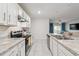 Modern kitchen with white cabinets, granite countertops, and stainless steel appliances at 723 Chinoy Rd, Davenport, FL 33837