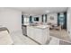 Open kitchen with island, stainless steel appliances, and view to dining area at 723 Chinoy Rd, Davenport, FL 33837